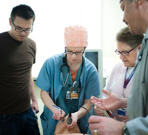 two women and two men stand on stairs